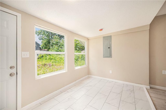 4036 Benton Blvd, Kansas City, MO 64130 - spare room featuring electric panel, light marble finish floors, and a textured ceiling