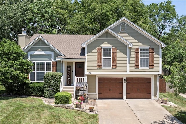 109 NW Whitlock Dr, Lees Summit, MO 64081 - tri-level home with driveway, a front yard, a garage, and a chimney