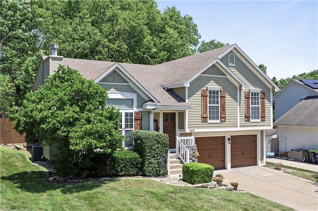 109 NW Whitlock Dr, Lees Summit, MO 64081 - split level home with a garage, concrete driveway, roof with shingles, and a front yard