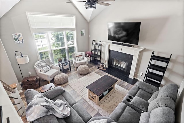 109 NW Whitlock Dr, Lees Summit, MO 64081 - living area with a ceiling fan, wood finished floors, a tile fireplace, and high vaulted ceiling