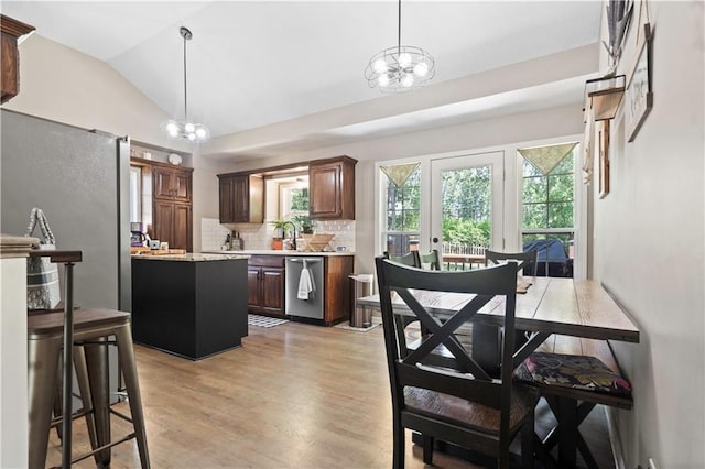 109 NW Whitlock Dr, Lees Summit, MO 64081 - dining space with a chandelier, lofted ceiling, and light wood-style flooring
