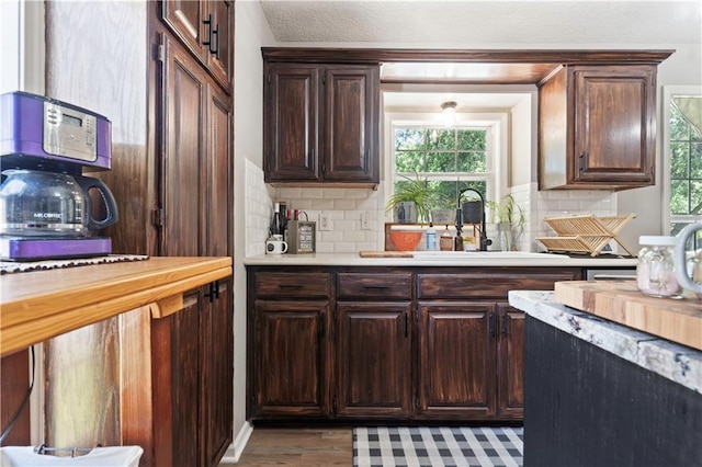 109 NW Whitlock Dr, Lees Summit, MO 64081 - kitchen with light countertops, plenty of natural light, backsplash, and dark brown cabinets