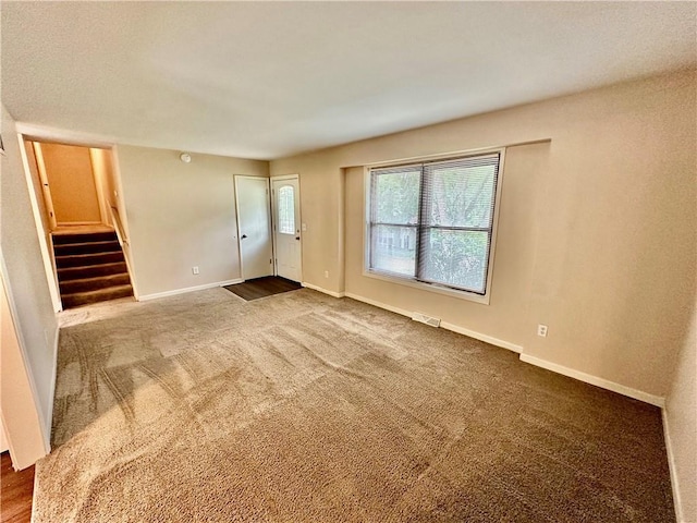 6110 NW 51st Ter, Kansas City, MO 64151 - carpeted empty room featuring stairway and baseboards