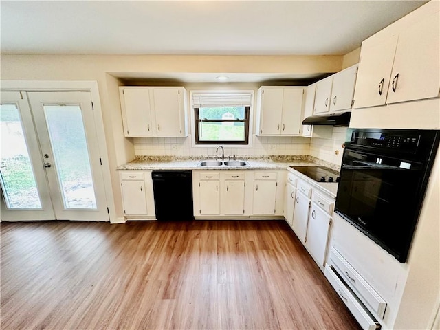 6110 NW 51st Ter, Kansas City, MO 64151 - kitchen featuring black appliances, under cabinet range hood, light countertops, and white cabinets