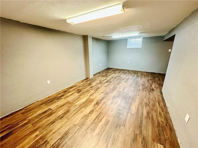 6110 NW 51st Ter, Kansas City, MO 64151 - basement with wood finished floors and a textured ceiling