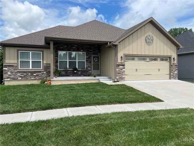 5205 University Ave, Saint Joseph, MO 64503 - craftsman inspired home featuring stone siding, an attached garage, a shingled roof, board and batten siding, and a front lawn