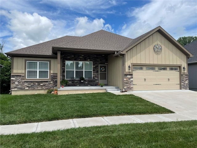 5205 University Ave, Saint Joseph, MO 64503 - view of front of home with stone siding, an attached garage, roof with shingles, and a front yard
