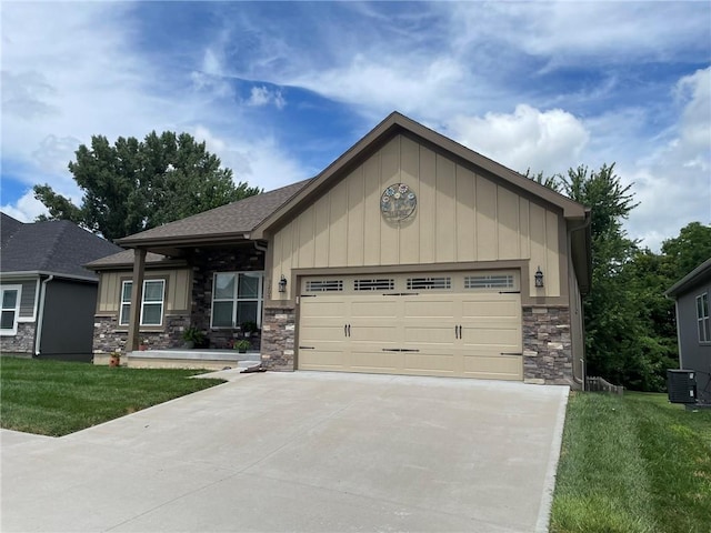 5205 University Ave, Saint Joseph, MO 64503 - view of front of home with stone siding, board and batten siding, an attached garage, concrete driveway, and a front lawn