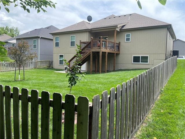 5205 University Ave, Saint Joseph, MO 64503 - rear view of property with a fenced backyard, stairway, a deck, and roof with shingles