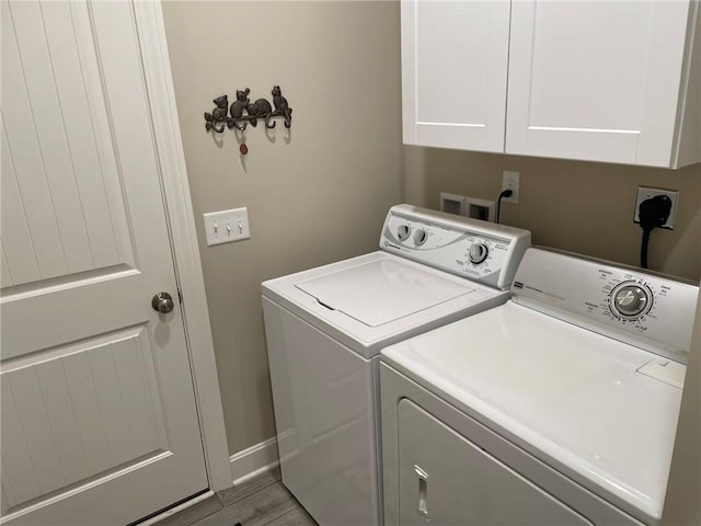 5205 University Ave, Saint Joseph, MO 64503 - laundry room with washer and dryer, cabinet space, and wood finished floors