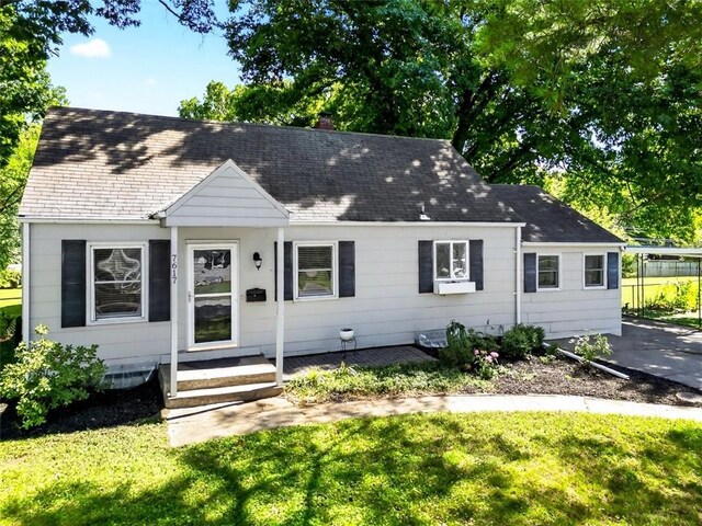 7617 W 63rd Ter, Overland Park, KS 66202 - cape cod home featuring a front lawn, a shingled roof, and a chimney