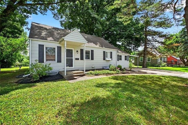 7617 W 63rd Ter, Overland Park, KS 66202 - view of front facade with a front lawn, a shingled roof, and driveway
