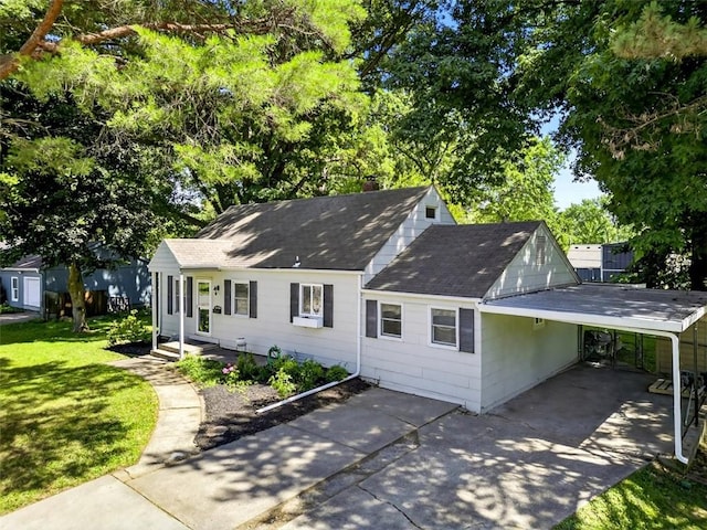 7617 W 63rd Ter, Overland Park, KS 66202 - view of front of home featuring concrete driveway, a carport, a shingled roof, and a front lawn