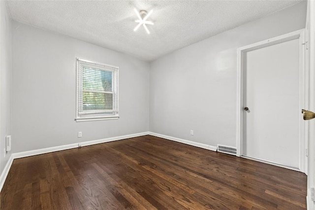 7617 W 63rd Ter, Overland Park, KS 66202 - empty room featuring a textured ceiling and dark wood-type flooring