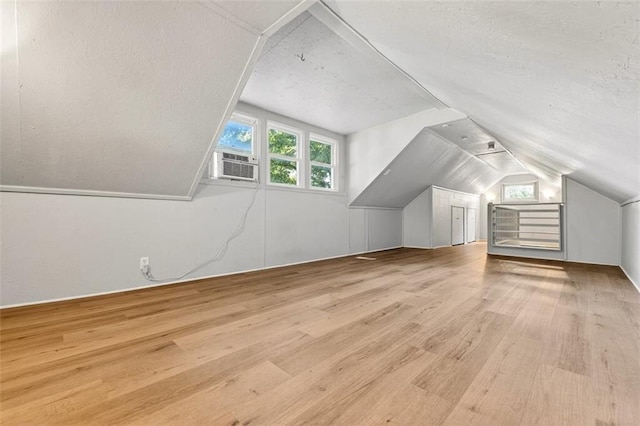 7617 W 63rd Ter, Overland Park, KS 66202 - bonus room featuring vaulted ceiling, wood finished floors, and a textured ceiling
