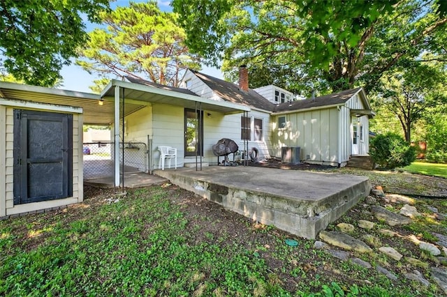 7617 W 63rd Ter, Overland Park, KS 66202 - rear view of property with board and batten siding, a patio area, and a gate