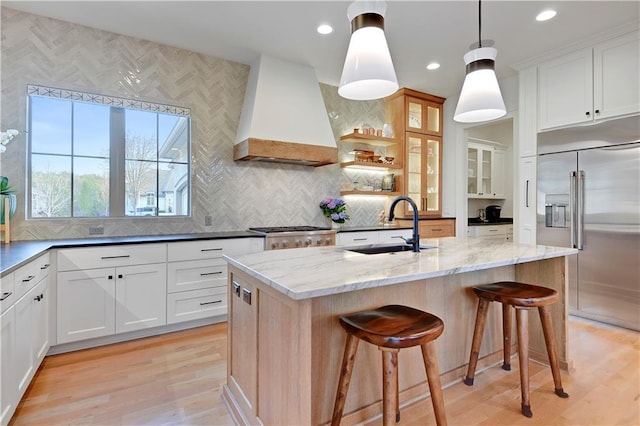 2144 W 89th Ter, Leawood, KS 66206 - kitchen featuring stainless steel built in refrigerator, custom range hood, light wood-style flooring, light stone counters, and recessed lighting