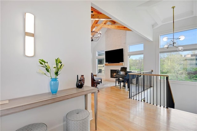2144 W 89th Ter, Leawood, KS 66206 - hall featuring a chandelier, beamed ceiling, an upstairs landing, light wood-type flooring, and high vaulted ceiling