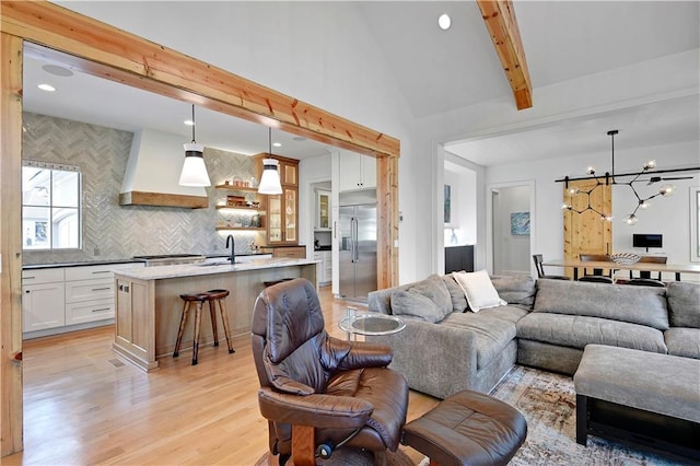 2144 W 89th Ter, Leawood, KS 66206 - living room featuring light wood finished floors, a chandelier, and recessed lighting