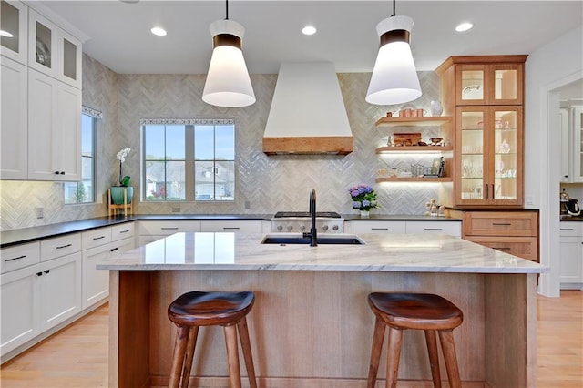 2144 W 89th Ter, Leawood, KS 66206 - kitchen featuring custom exhaust hood, backsplash, a breakfast bar area, light wood finished floors, and recessed lighting