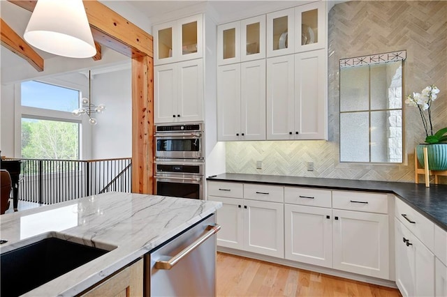 2144 W 89th Ter, Leawood, KS 66206 - kitchen with appliances with stainless steel finishes, backsplash, dark stone countertops, white cabinets, and glass insert cabinets