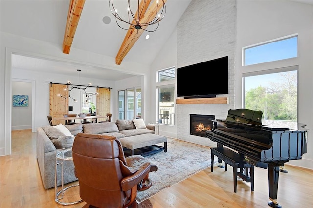 2144 W 89th Ter, Leawood, KS 66206 - living area with a chandelier, high vaulted ceiling, wood finished floors, a large fireplace, and beamed ceiling