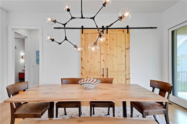 2144 W 89th Ter, Leawood, KS 66206 - dining area with a barn door and light wood-type flooring