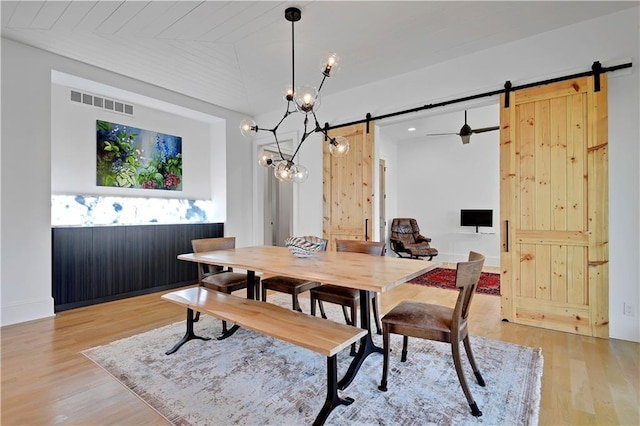 2144 W 89th Ter, Leawood, KS 66206 - dining area featuring a barn door, light wood-type flooring, and a chandelier