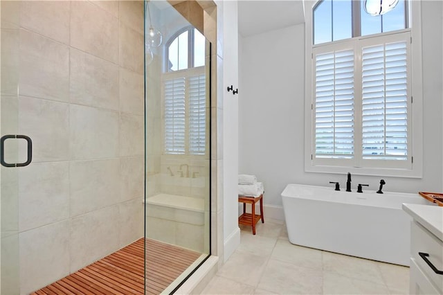 2144 W 89th Ter, Leawood, KS 66206 - full bath with a stall shower, tile patterned flooring, a soaking tub, and vanity