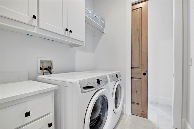 2144 W 89th Ter, Leawood, KS 66206 - laundry room featuring cabinet space, washing machine and clothes dryer, and light tile patterned floors