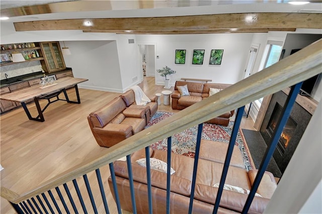 2144 W 89th Ter, Leawood, KS 66206 - living area featuring beamed ceiling, light wood-style floors, and a high end fireplace