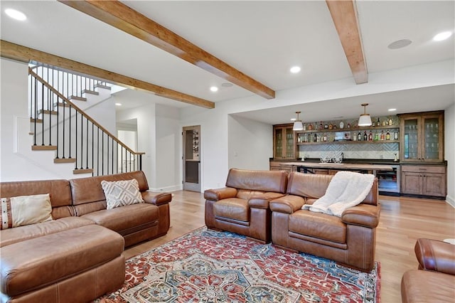 2144 W 89th Ter, Leawood, KS 66206 - living room featuring beverage cooler, wet bar, recessed lighting, light wood finished floors, and beam ceiling