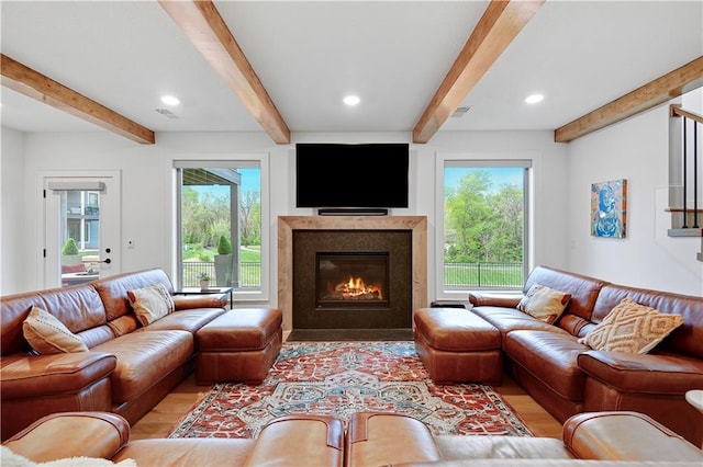2144 W 89th Ter, Leawood, KS 66206 - living area with beamed ceiling, light wood-type flooring, plenty of natural light, a glass covered fireplace, and recessed lighting