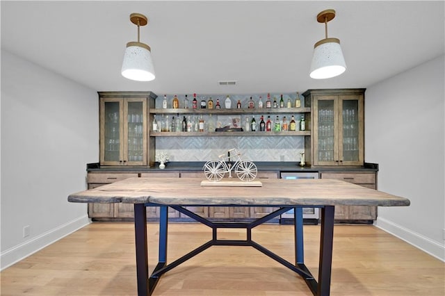 2144 W 89th Ter, Leawood, KS 66206 - indoor bar featuring decorative light fixtures, wine cooler, and light wood-style flooring