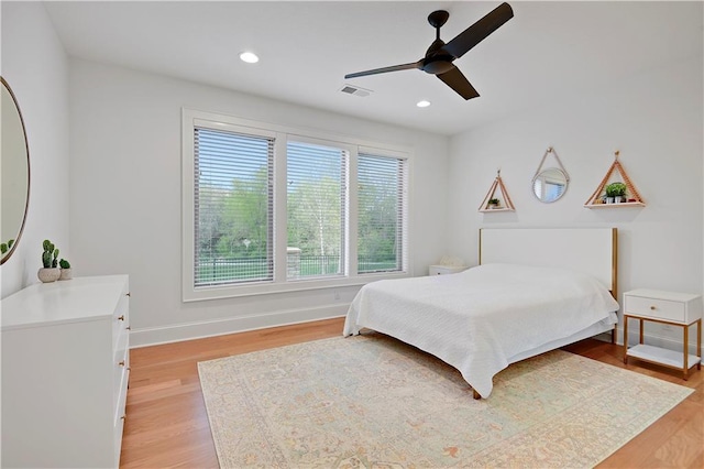 2144 W 89th Ter, Leawood, KS 66206 - bedroom with light wood-style flooring, a ceiling fan, and recessed lighting