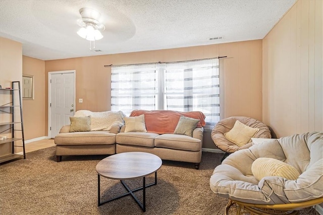 810 Vest Dr, Warrensburg, MO 64093 - living room featuring carpet flooring, a textured ceiling, and a ceiling fan