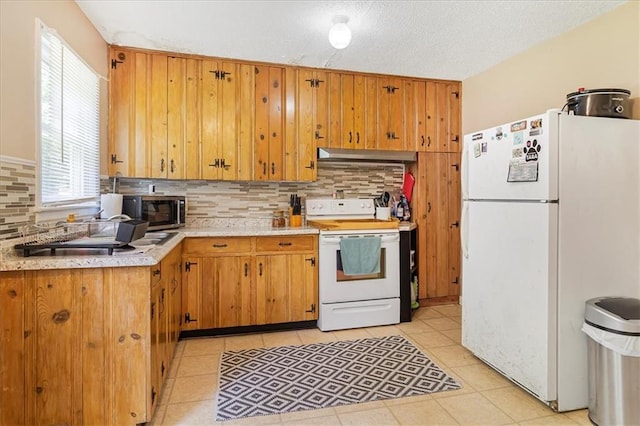 810 Vest Dr, Warrensburg, MO 64093 - kitchen with white appliances, light countertops, decorative backsplash, under cabinet range hood, and brown cabinetry