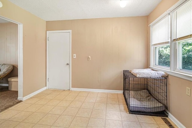 810 Vest Dr, Warrensburg, MO 64093 - living area with a textured ceiling and wood walls