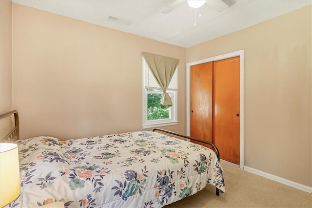 810 Vest Dr, Warrensburg, MO 64093 - carpeted bedroom with a closet and a ceiling fan