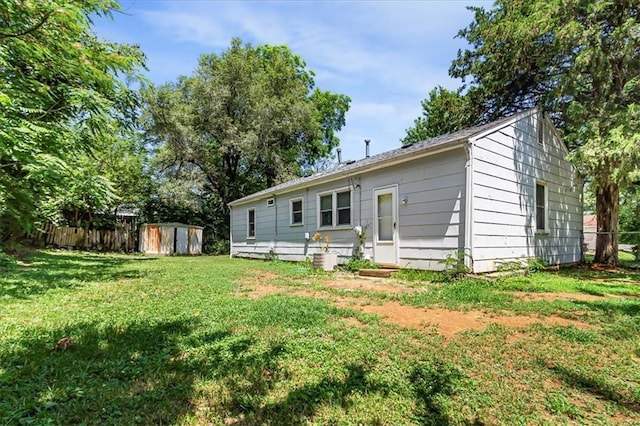 810 Vest Dr, Warrensburg, MO 64093 - rear view of property featuring a storage shed