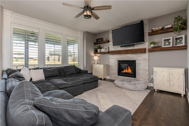 25096 W 87th St, Lenexa, KS 66227 - living room featuring a ceiling fan, dark wood-type flooring, and a stone fireplace