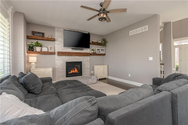 25096 W 87th St, Lenexa, KS 66227 - living area featuring dark wood-type flooring, a ceiling fan, and a large fireplace