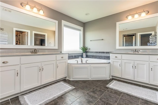 25096 W 87th St, Lenexa, KS 66227 - full bathroom with two vanities, a bath, and tile patterned flooring