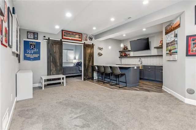 25096 W 87th St, Lenexa, KS 66227 - kitchen with a barn door, carpet floors, a breakfast bar, recessed lighting, and open shelves