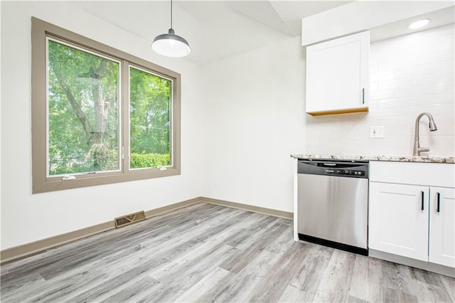 804 NW N Summit Cir, Blue Springs, MO 64015 - kitchen featuring stainless steel dishwasher, light stone countertops, decorative backsplash, white cabinetry, and vaulted ceiling