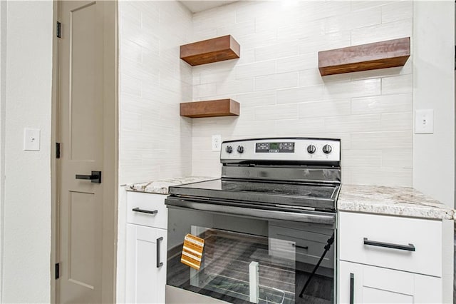 804 NW N Summit Cir, Blue Springs, MO 64015 - kitchen with electric range, open shelves, light stone countertops, and white cabinetry