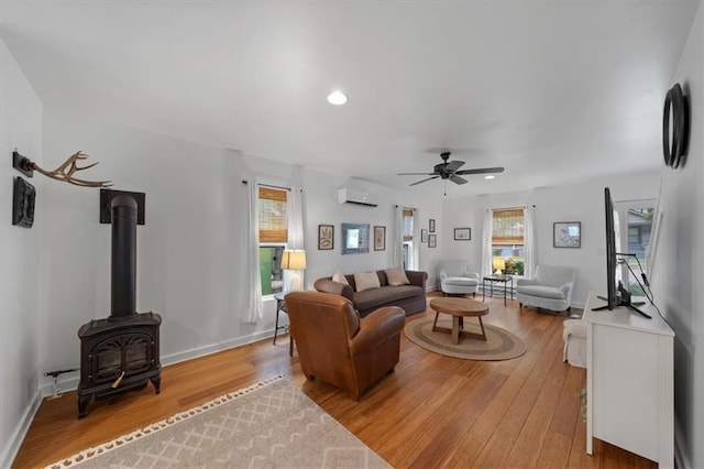 2017 W 48th St, Westwood, KS 66205 - living area with light wood finished floors, an AC wall unit, ceiling fan, a wood stove, and recessed lighting