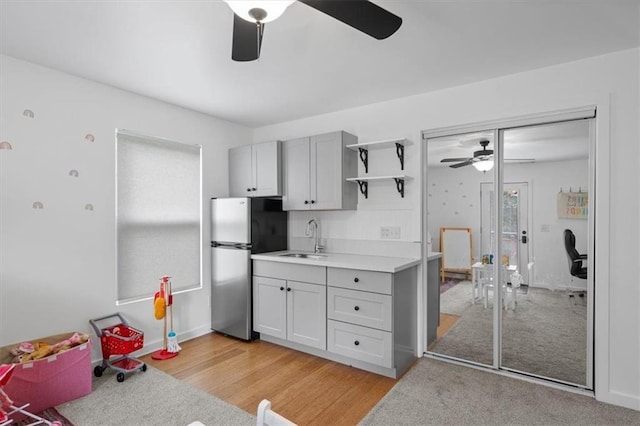 2017 W 48th St, Westwood, KS 66205 - kitchen featuring a ceiling fan, freestanding refrigerator, open shelves, light countertops, and light wood-style floors