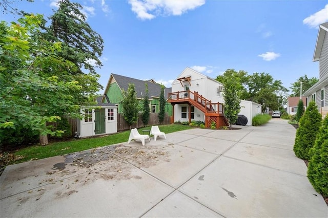2017 W 48th St, Westwood, KS 66205 - view of front of home featuring stairs, an outbuilding, a patio area, and a residential view