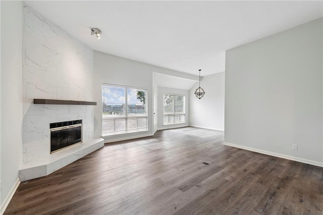 11224 Nieman Rd Unit 302, Overland Park, KS 66210 - unfurnished living room featuring a fireplace, wood finished floors, and a chandelier